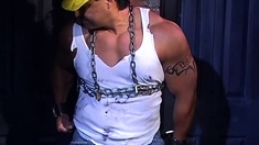 Muscular Construction Worker Is Bound Up With Chains